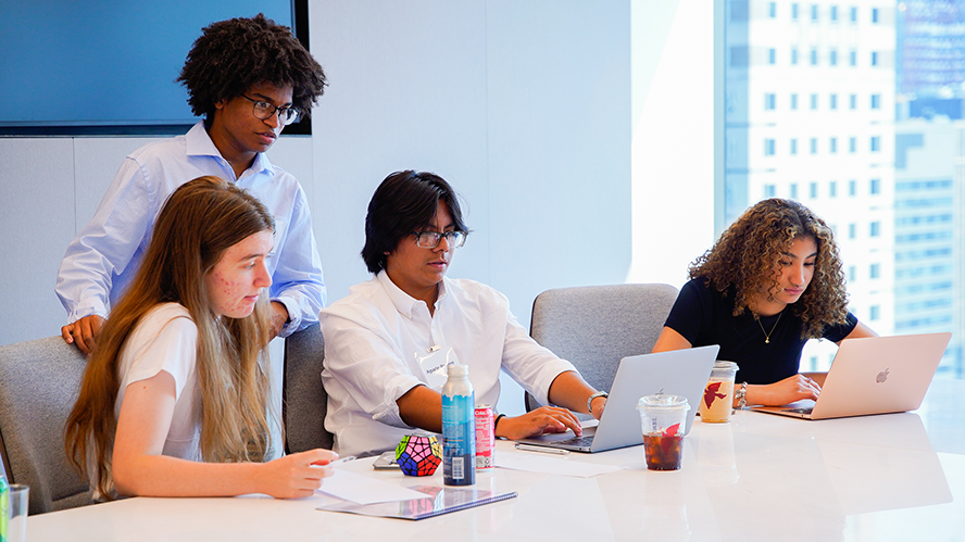 Colleagues sitting at a table drinking coffee