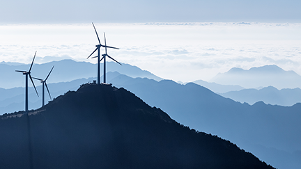 windmills on a hill with blue sky in the background 